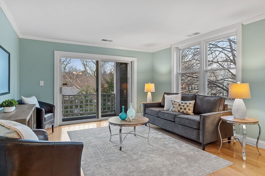 25 Holly Lane, Unit 2A Brookline, MA 02467 - Photo 2 of 34 a living room with furniture and a large window