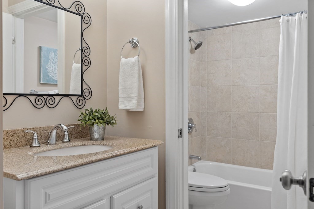 25 Holly Lane, Unit 2A Brookline, MA 02467 - Photo 21 of 34 a bathroom with a granite countertop sink toilet and shower