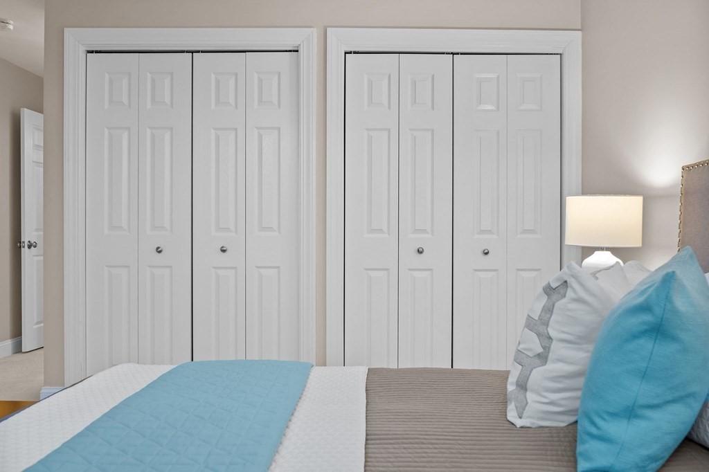 25 Holly Lane, Unit 2A Brookline, MA 02467 - Photo 22 of 34 a bedroom with a bed and a curtain