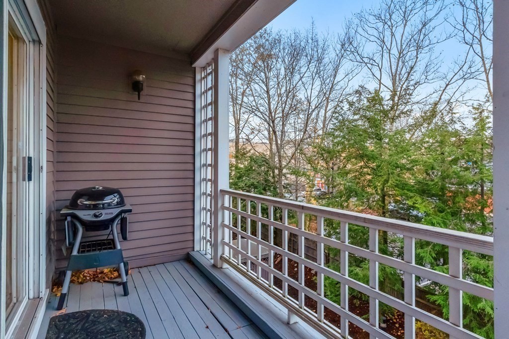 25 Holly Lane, Unit 2A Brookline, MA 02467 - Photo 23 of 34 a view of balcony with wooden floor and fence