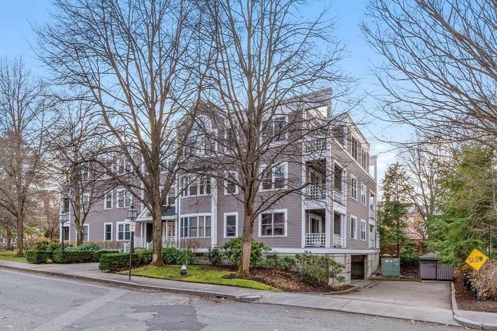 25 Holly Lane, Unit 2A Brookline, MA 02467 - Photo 26 of 34 a front view of a building with a garden