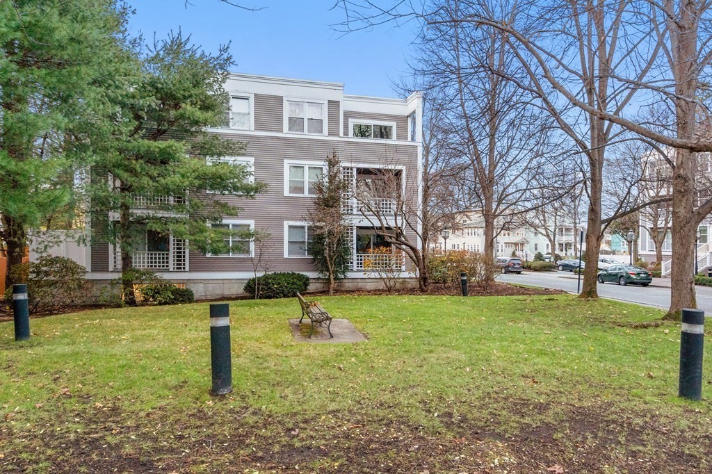 25 Holly Lane, Unit 2A Brookline, MA 02467 - Photo 29 of 34 a front view of a house with a yard