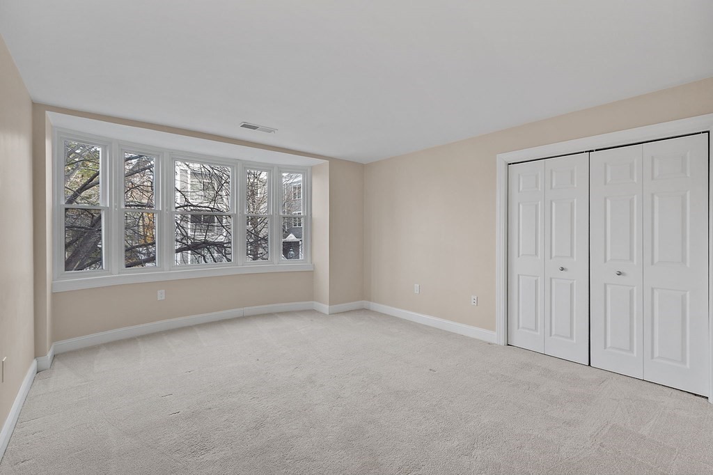 25 Holly Lane, Unit 2A Brookline, MA 02467 - Photo 4 of 34 a view of an empty room with a window