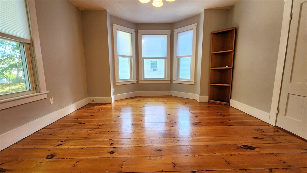 8 Fay Street, Unit 2 Westborough, MA 01581 - Photo 6 of 15 an empty room with wooden floor and windows