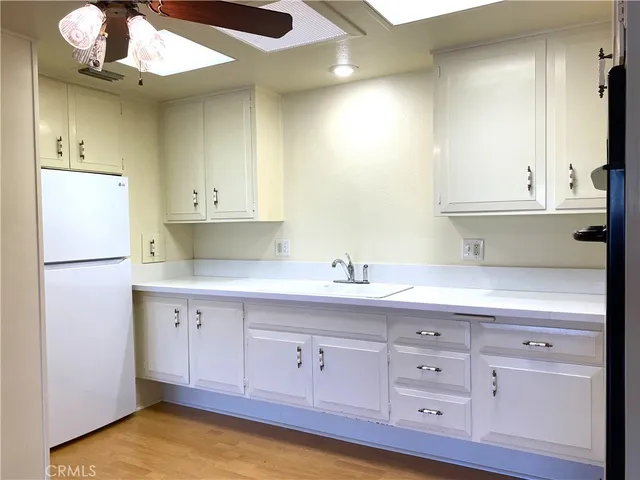 a kitchen with cabinets appliances and a sink