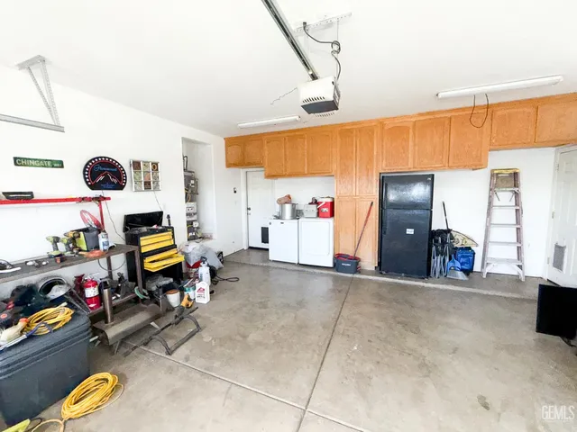 a view of a patio with table and chairs a barbeque with wooden fence