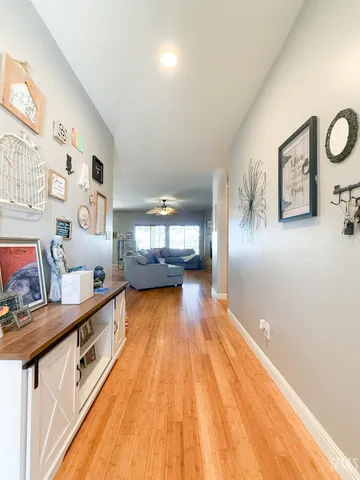 a view of a hallway with wooden floor