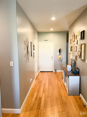 a bedroom with a bed and painting on the wall