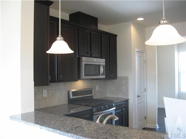 9117 Falkwood Road, Unit 159 Raleigh, NC 27617 - Photo 2 of 17 Dark Kona cabinets with granite countertops!