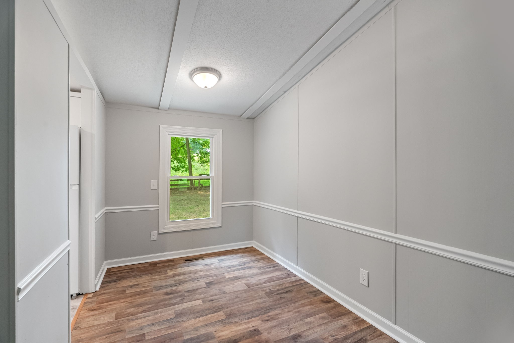 4147 Fizer Road Springfield, TN 37172 - Photo 11 of 25 a view of an empty room with wooden floor and a window