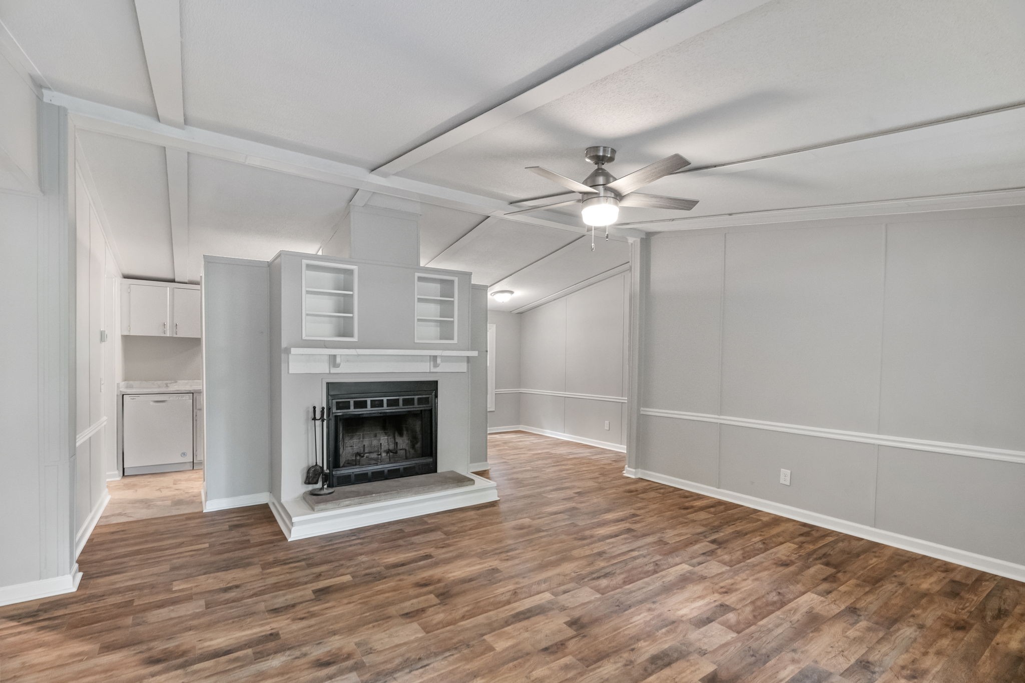 4147 Fizer Road Springfield, TN 37172 - Photo 6 of 25 a view of an empty room with wooden floor fireplace and a window