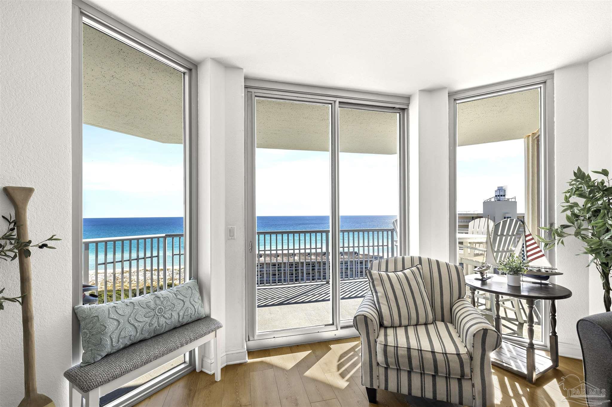 850 Fort Pickens Road, Unit 1040 Pensacola Beach, FL 32561 - Photo 13 of 37 a living room with furniture and a floor to ceiling window