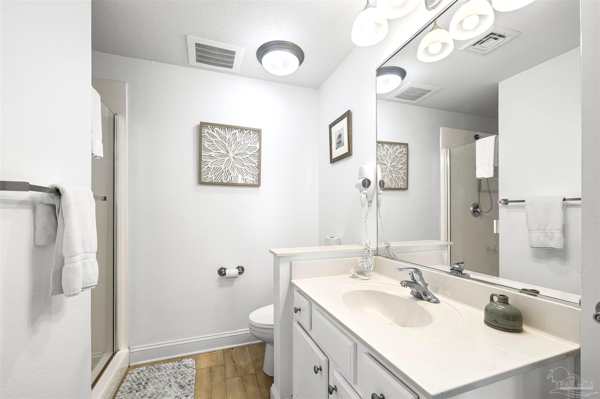 850 Fort Pickens Road, Unit 1040 Pensacola Beach, FL 32561 - Photo 20 of 37 a bathroom with a sink a toilet and a mirror