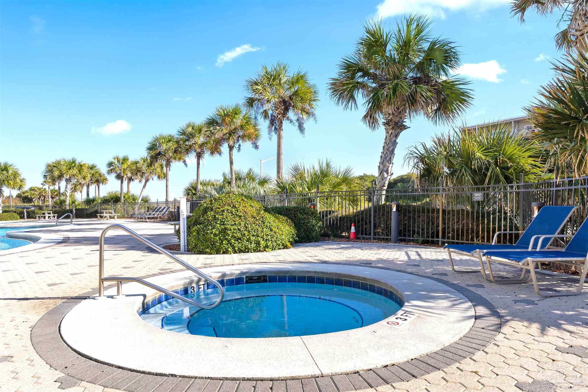 850 Fort Pickens Road, Unit 1040 Pensacola Beach, FL 32561 - Photo 5 of 37 a swimming pool with outdoor seating and yard