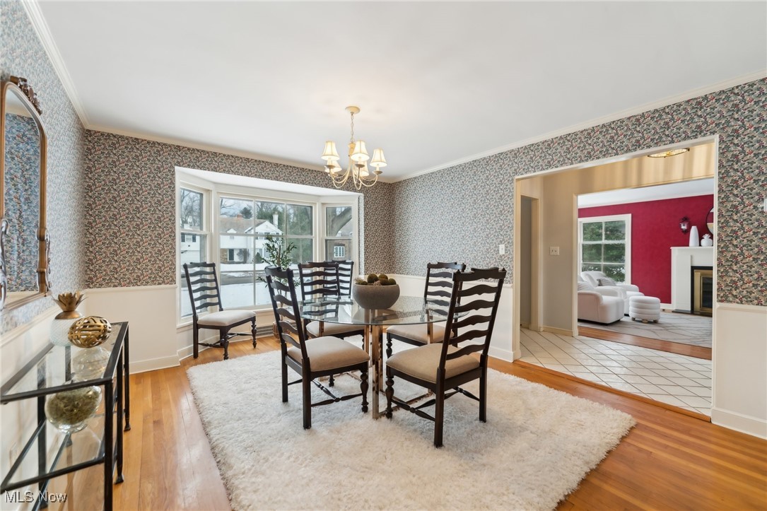 1542 Kew Road Cleveland, OH 44118 - Photo 6 of 23 Dining space with crown molding, a healthy amount of sunlight, and hardwood / wood-style flooring