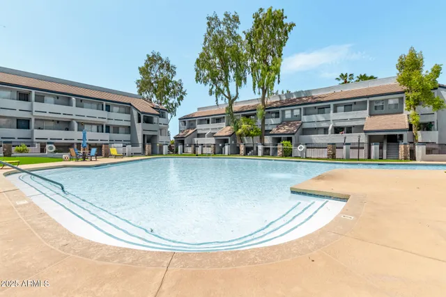 swimming pool view with a seating space and a garden