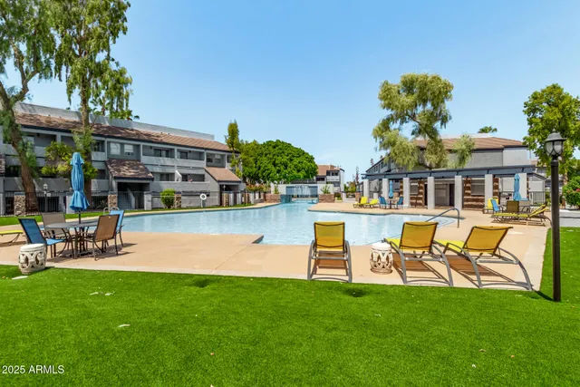 a swimming pool with outdoor seating and yard
