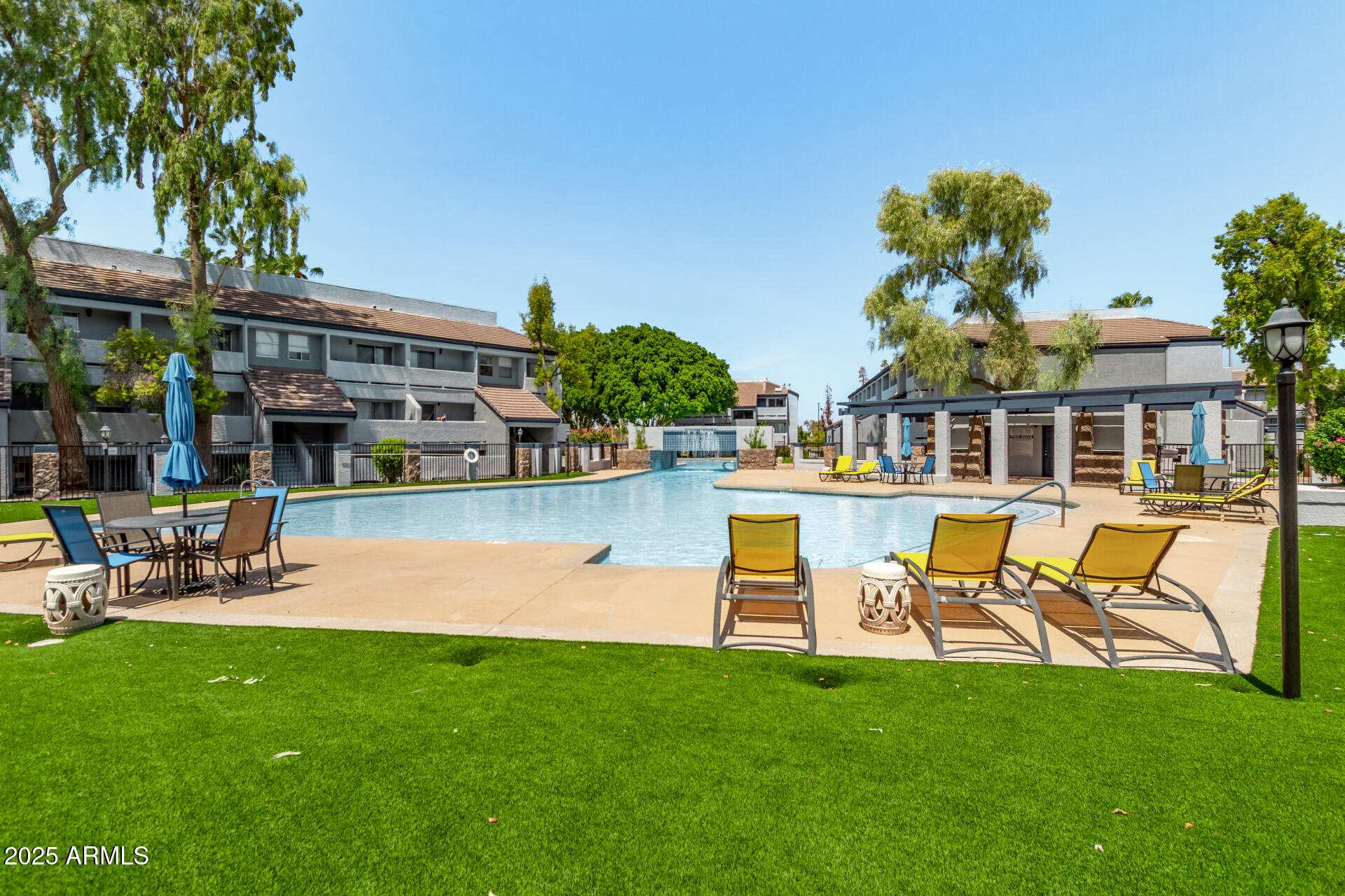 1331 West Baseline Road, Unit 153 Mesa, AZ 85202 - Photo 21 of 25 a swimming pool with outdoor seating and yard