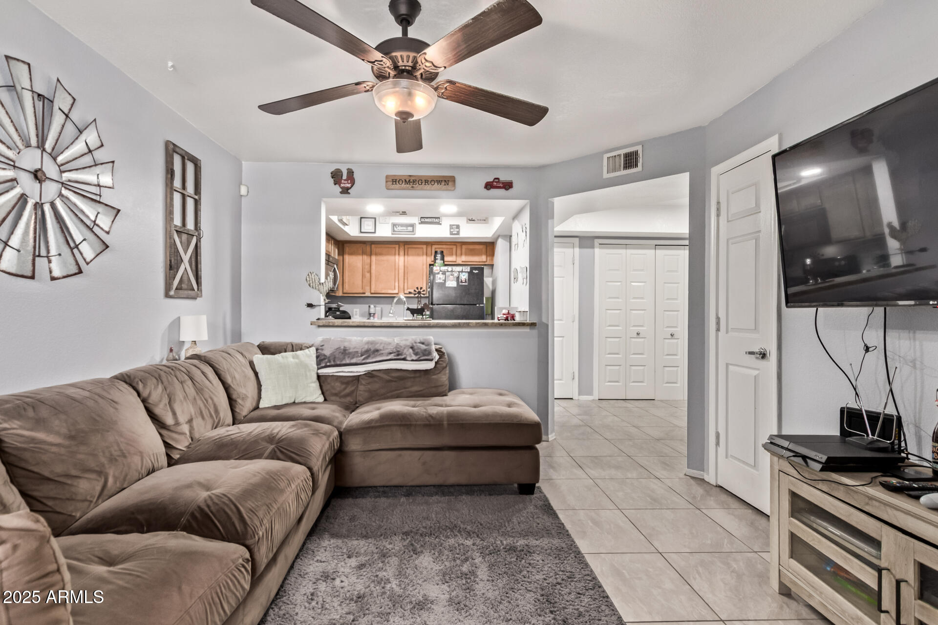 1331 West Baseline Road, Unit 153 Mesa, AZ 85202 - Photo 22 of 25 a living room with furniture and a flat screen tv