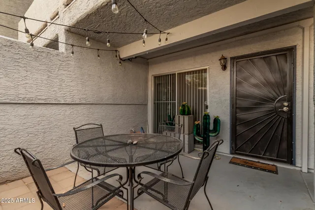 a backyard of a house with table and chairs