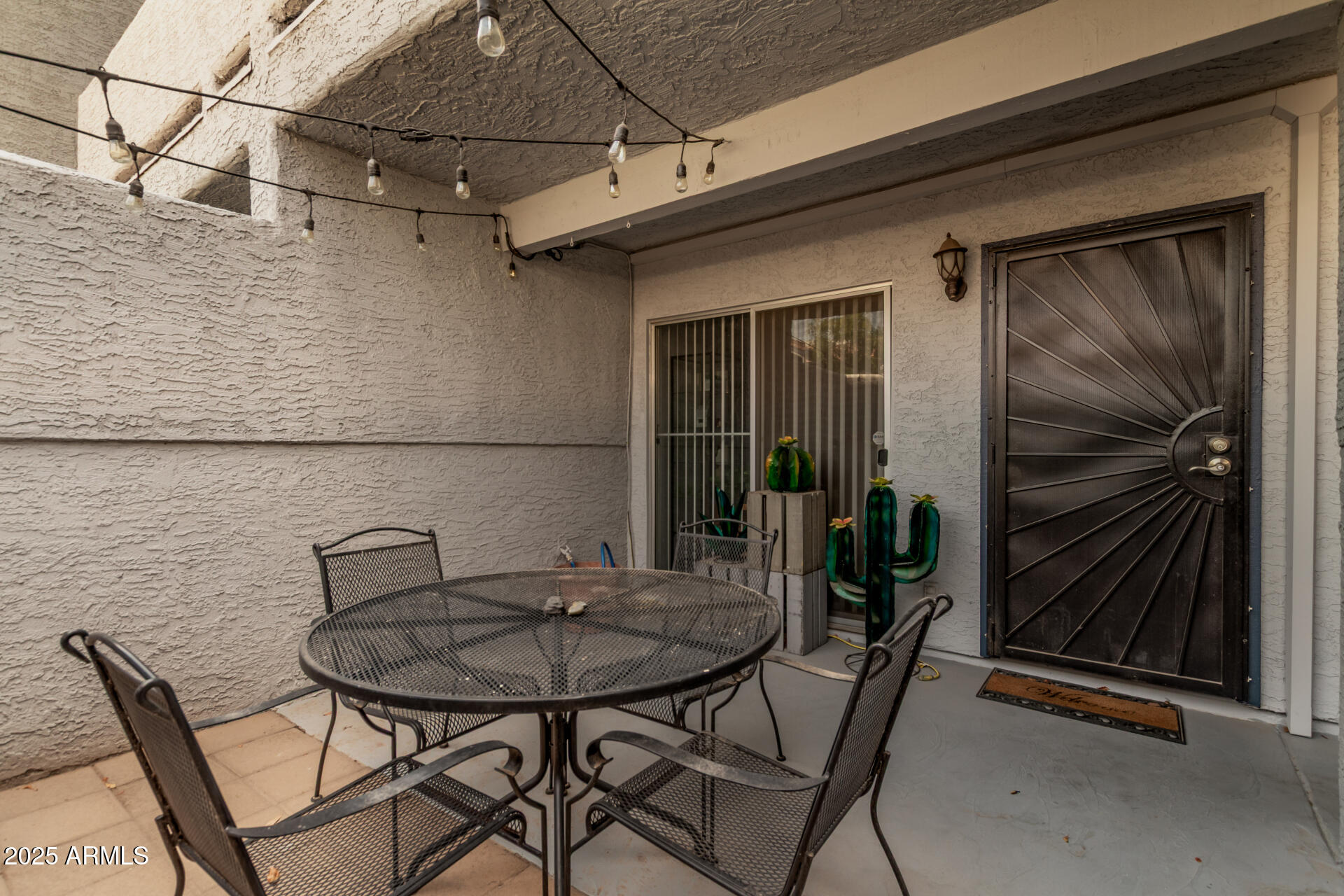 1331 West Baseline Road, Unit 153 Mesa, AZ 85202 - Photo 25 of 25 a backyard of a house with table and chairs