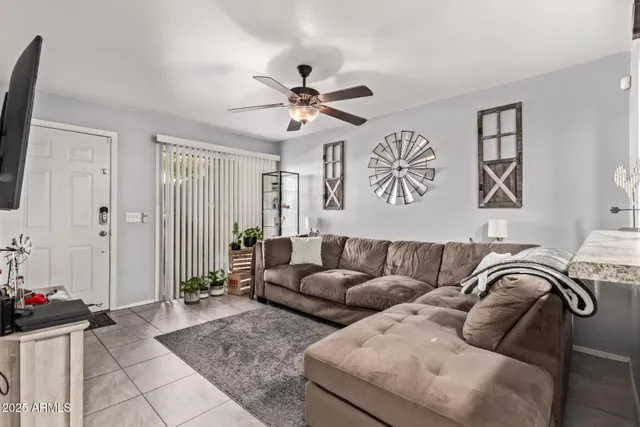 a living room with furniture ceiling fan and a rug