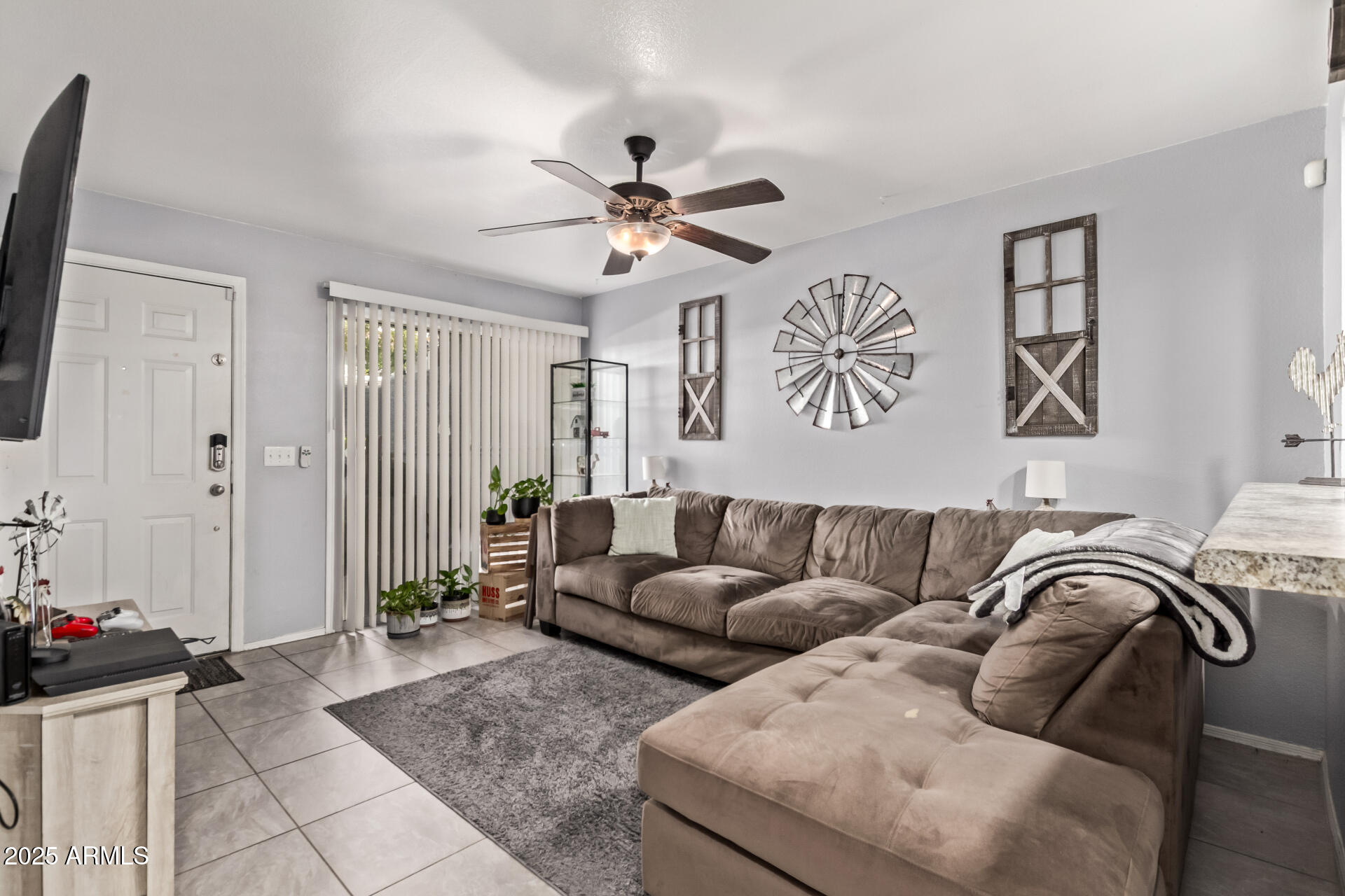 1331 West Baseline Road, Unit 153 Mesa, AZ 85202 - Photo 4 of 25 a living room with furniture ceiling fan and a rug
