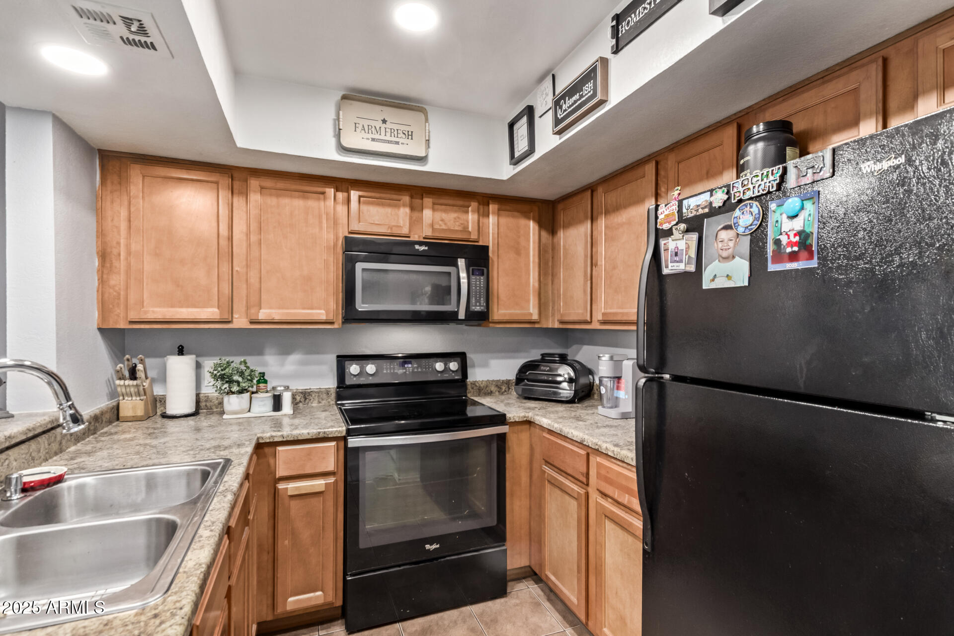 1331 West Baseline Road, Unit 153 Mesa, AZ 85202 - Photo 10 of 25 a kitchen with stainless steel appliances granite countertop a refrigerator and a sink