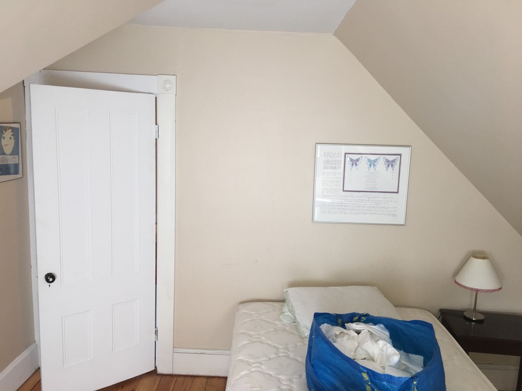 12 Union Street Beverly, MA 01915 - Photo 12 of 19 a bedroom with a bed and a window