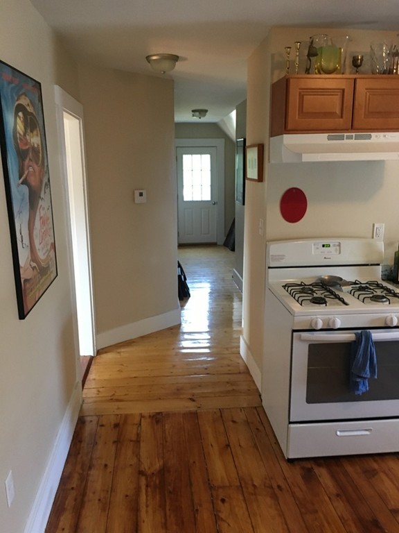 12 Union Street Beverly, MA 01915 - Photo 15 of 19 a kitchen with a stove and a wooden floor