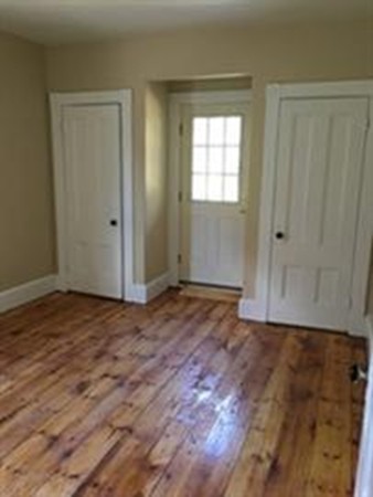 12 Union Street Beverly, MA 01915 - Photo 4 of 19 a view of an empty room with wooden floor and a window