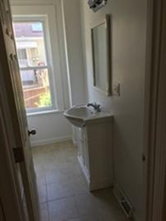 12 Union Street Beverly, MA 01915 - Photo 5 of 19 a bathroom with a sink a vanity and a mirror