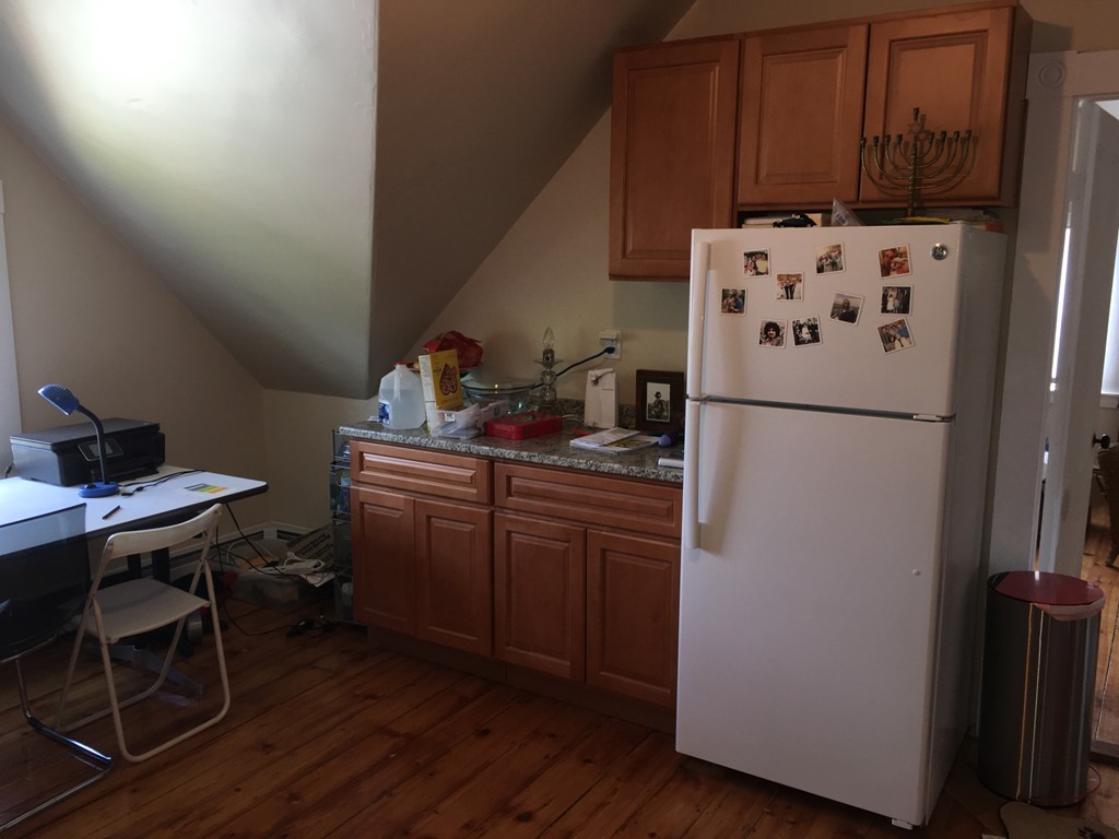 12 Union Street Beverly, MA 01915 - Photo 9 of 19 a kitchen with refrigerator a stove a microwave and a dining table