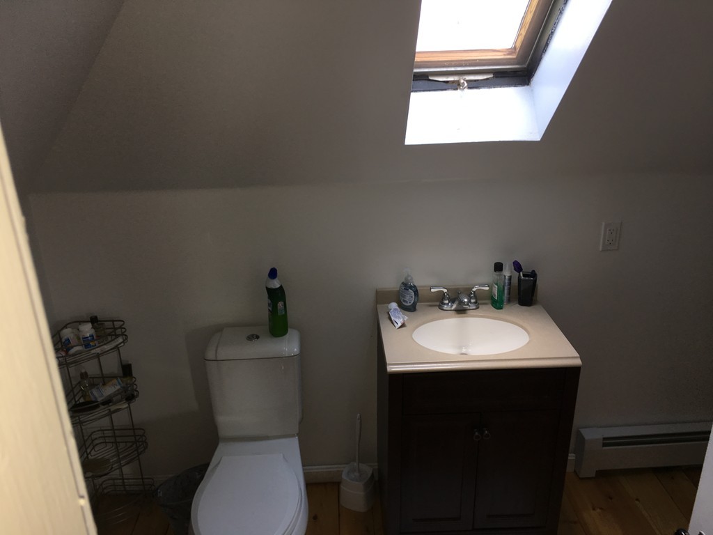 12 Union Street Beverly, MA 01915 - Photo 10 of 19 a bathroom with a toilet sink and mirror