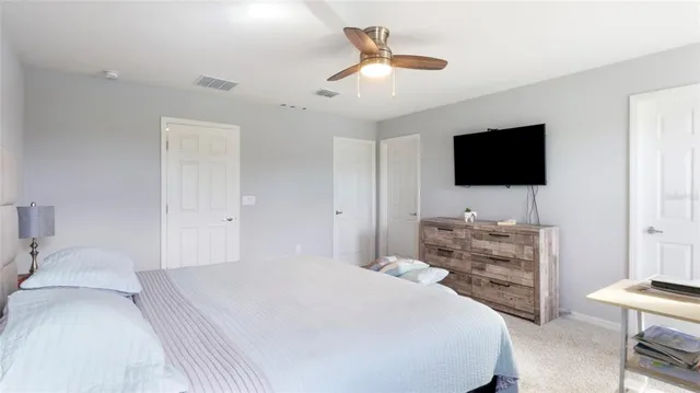 a bedroom with a bed and a flat screen television