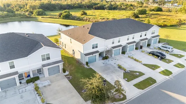 an aerial view of house with ocean view