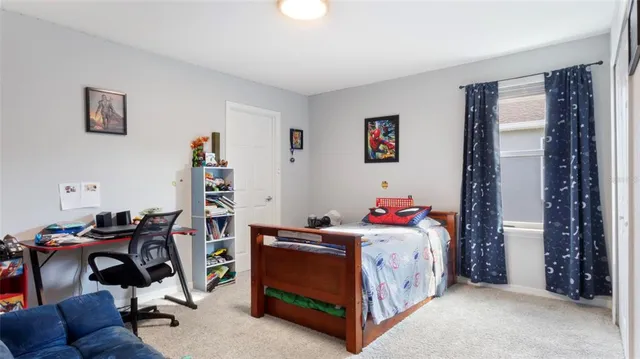 a bedroom with a bed and a chair