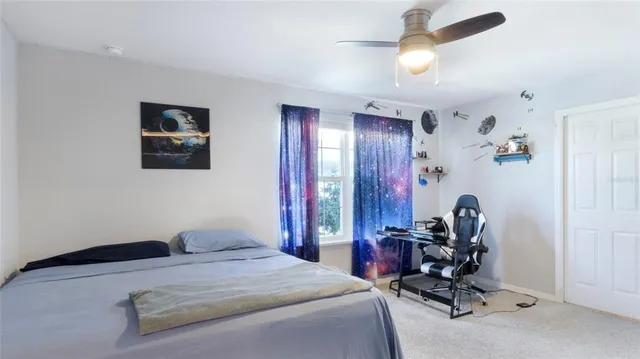 a bedroom with a bed and a chair