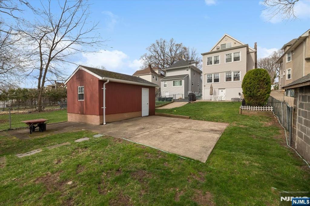 119 Overpeck Avenue Ridgefield Park, NJ 07660 - Photo 31 of 44 a view of a house with a yard and large trees