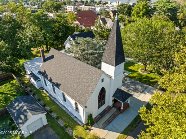 an aerial view of a house with a yard and trees