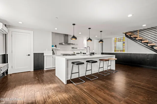 a kitchen with stainless steel appliances a stove a sink and a refrigerator