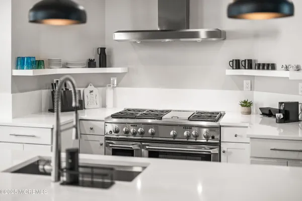 a white stove top oven sitting inside of a kitchen