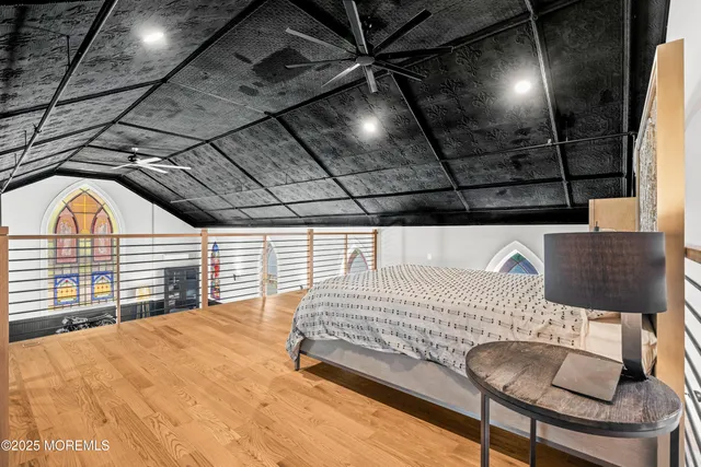 a bedroom with a bed and a chandelier