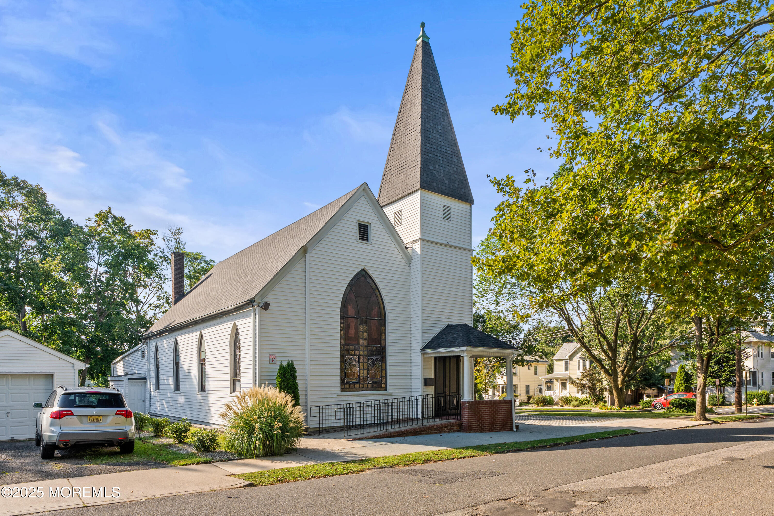 73 3rd Avenue, Unit A Atlantic Highlands, NJ 07716 - Photo 2 of 19 a view of a white house next to a road and large trees