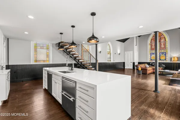 a kitchen with stove and chairs