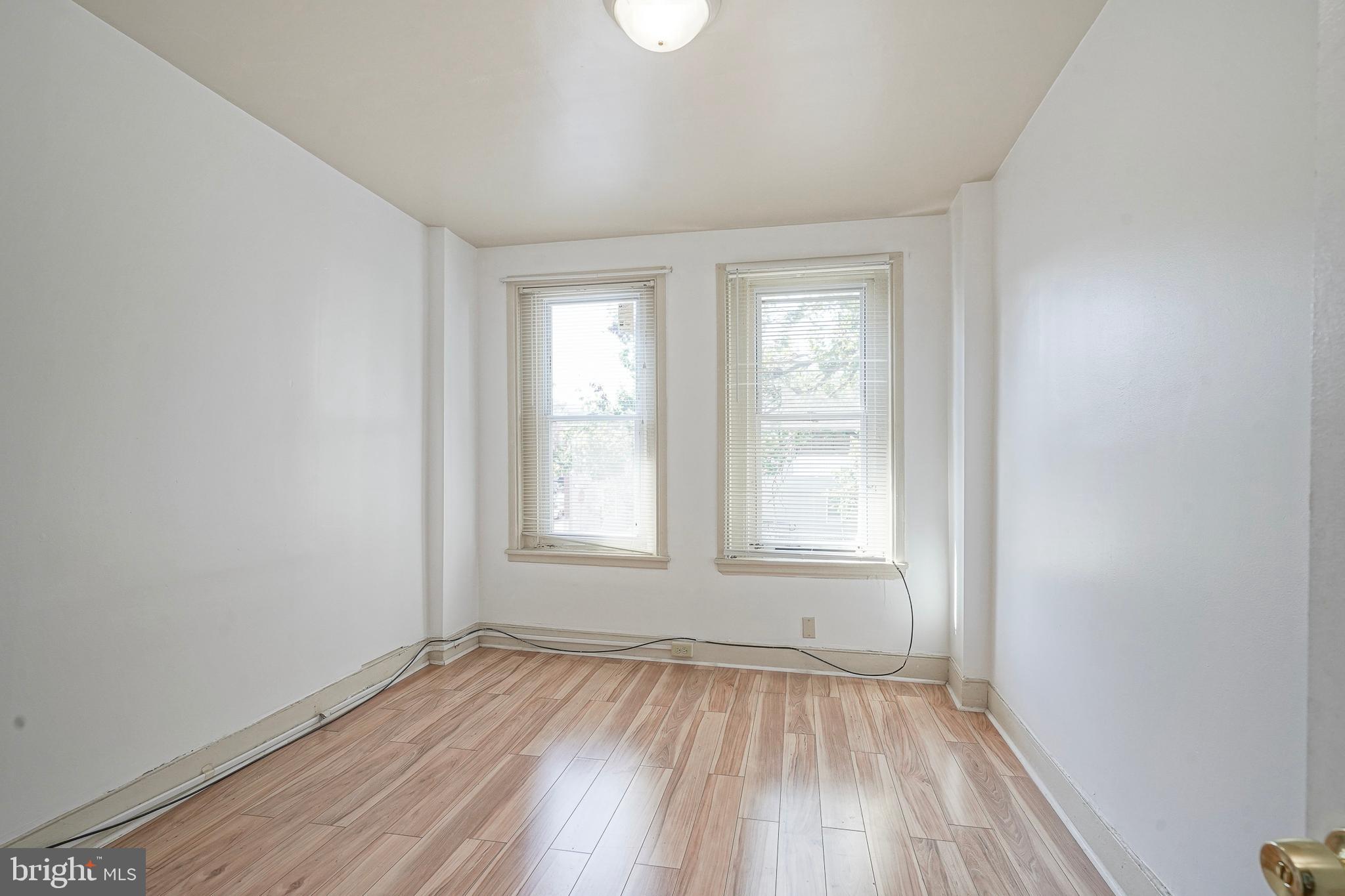 1904 Federal Street Philadelphia, PA 19146 - Photo 14 of 22 an empty room with wooden floor and windows