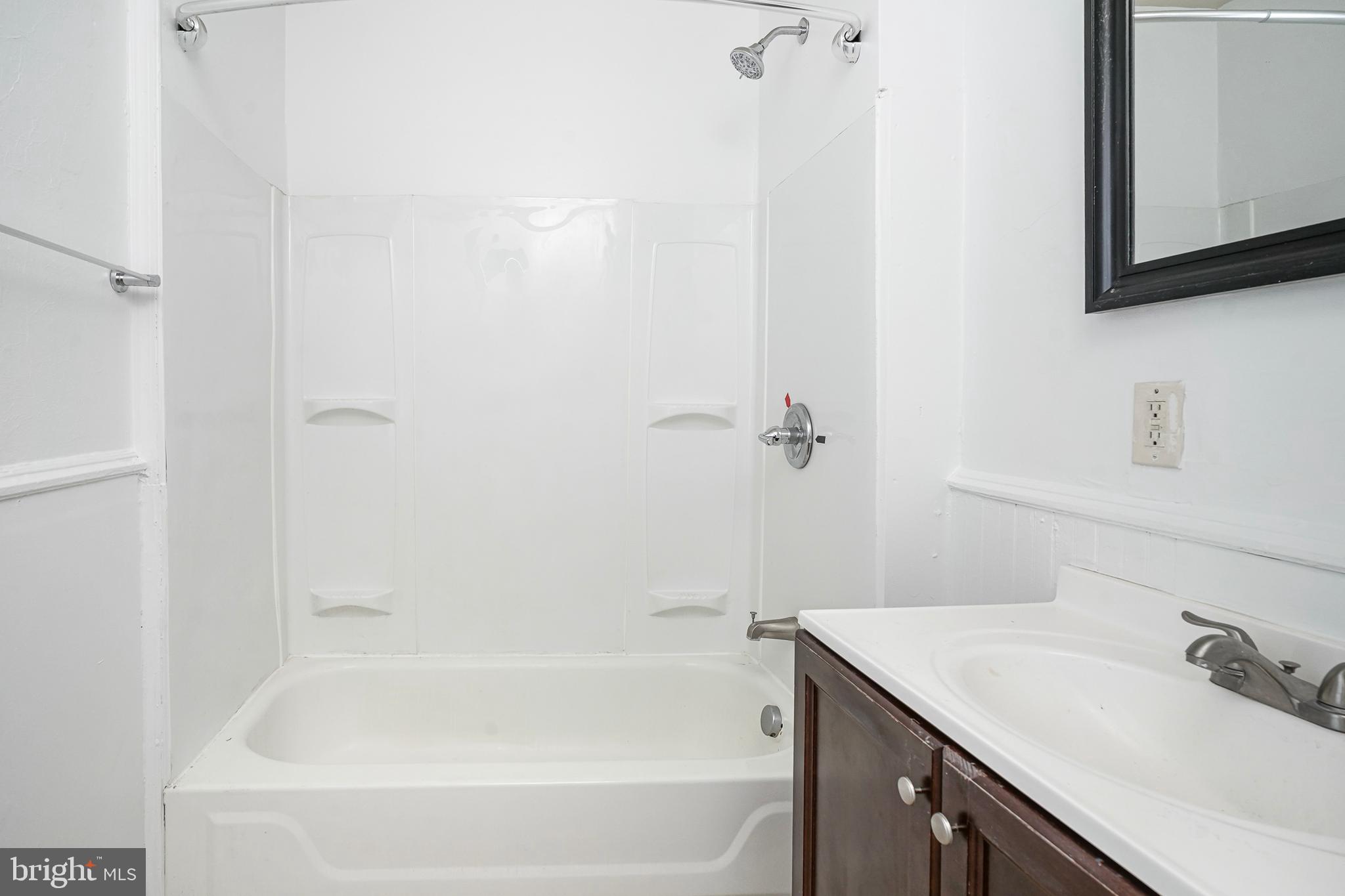 1904 Federal Street Philadelphia, PA 19146 - Photo 16 of 22 a bath room with a sink vanity tub and a mirror