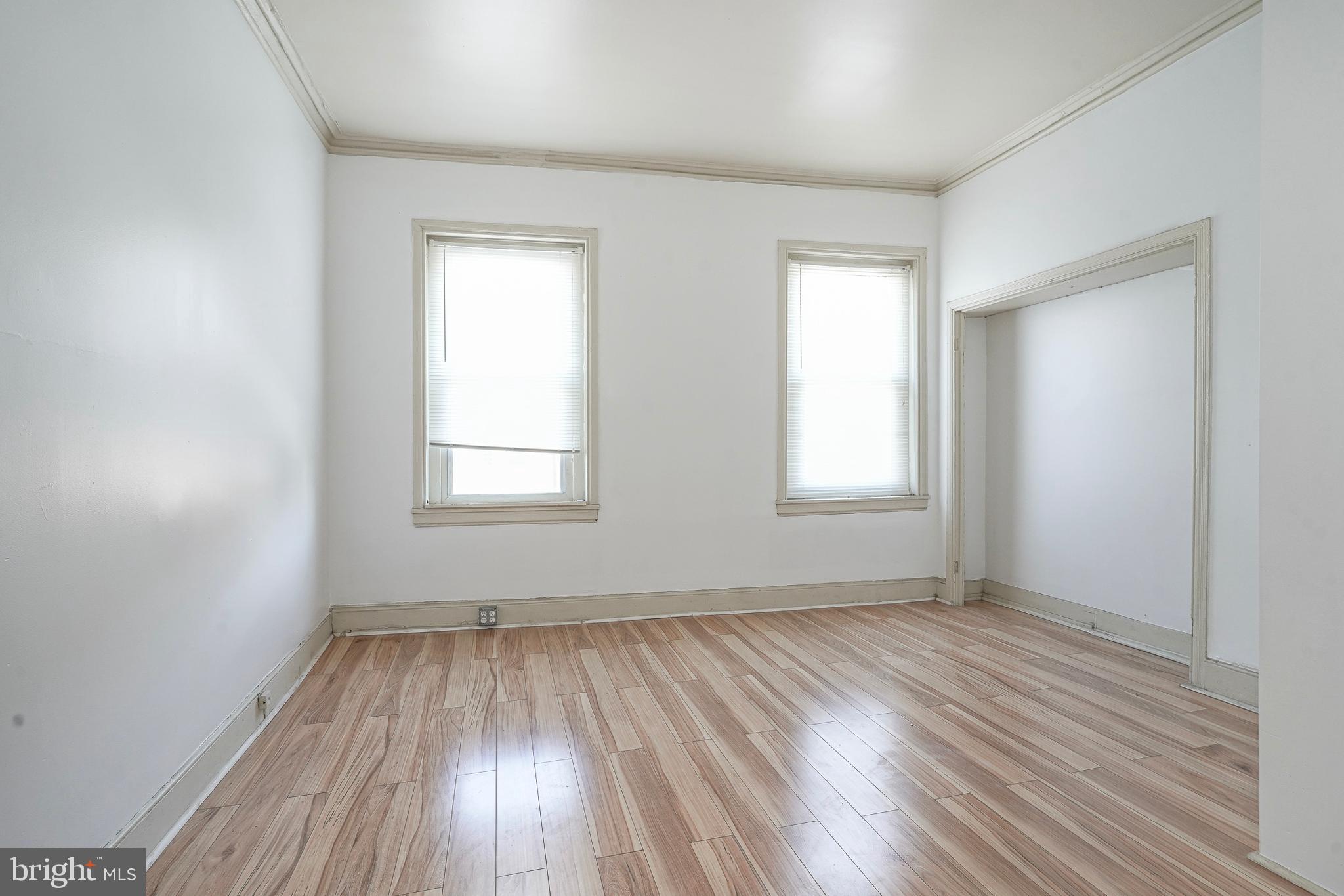 1904 Federal Street Philadelphia, PA 19146 - Photo 19 of 22 an empty room with wooden floor and windows