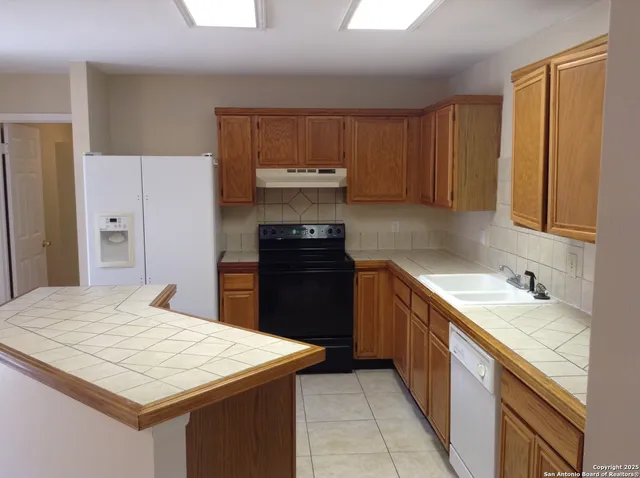 a kitchen with a stove and a refrigerator