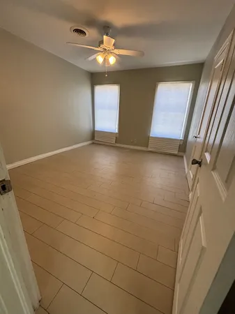 a view of an empty room with windows